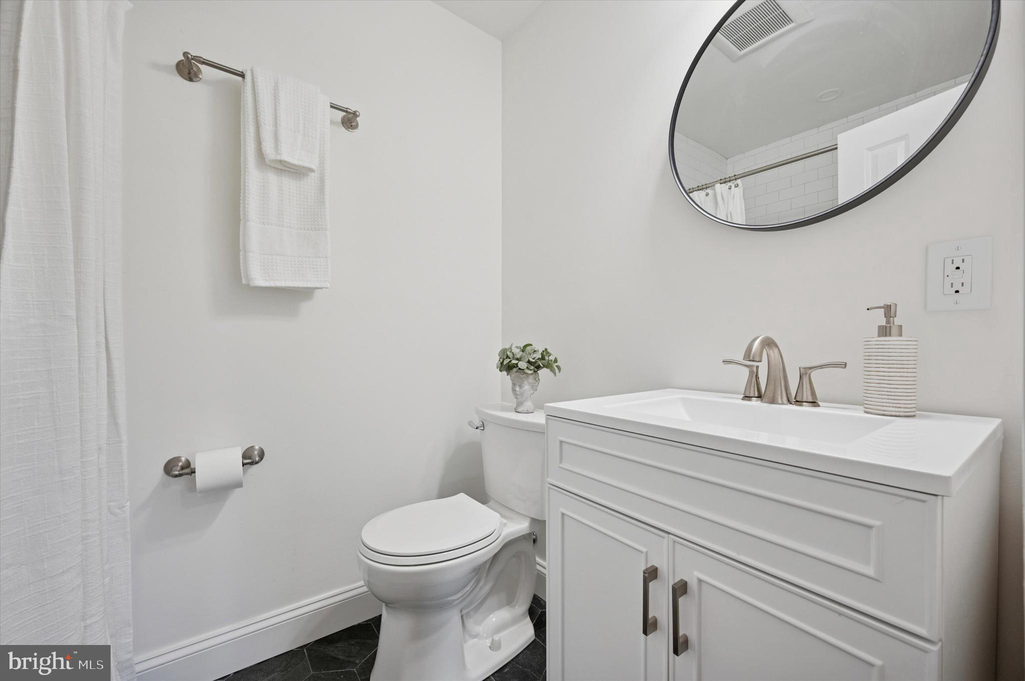 2308 Poplar Road Havertown, PA 19083 - Photo 19 of 25 a bathroom with a sink a toilet and a mirror