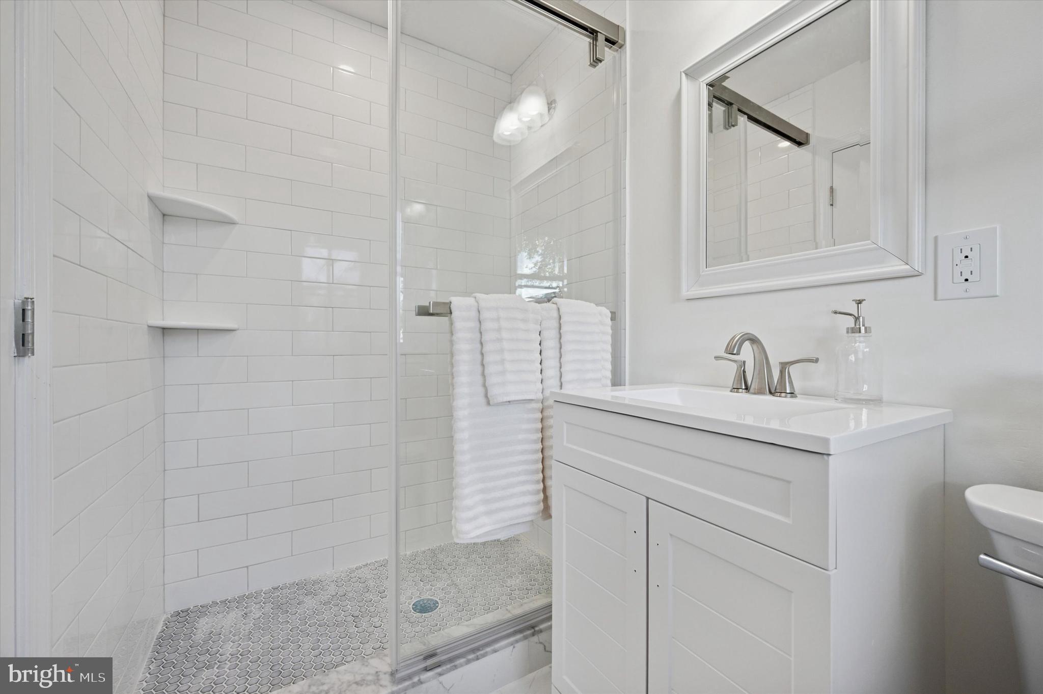 2308 Poplar Road Havertown, PA 19083 - Photo 21 of 25 a bathroom with a shower sink and mirror