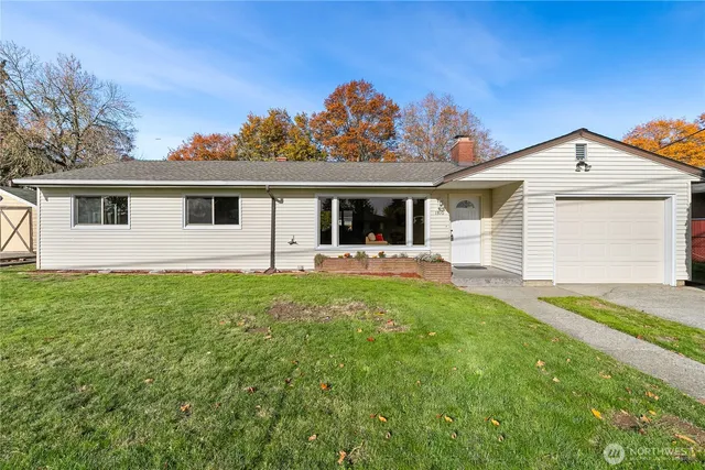 a front view of house with yard and green space