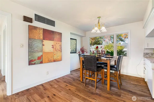 a view of a dining room with furniture window and wooden floor
