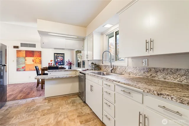 a kitchen with a sink cabinets and window