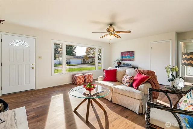 a living room with furniture and a wooden floor