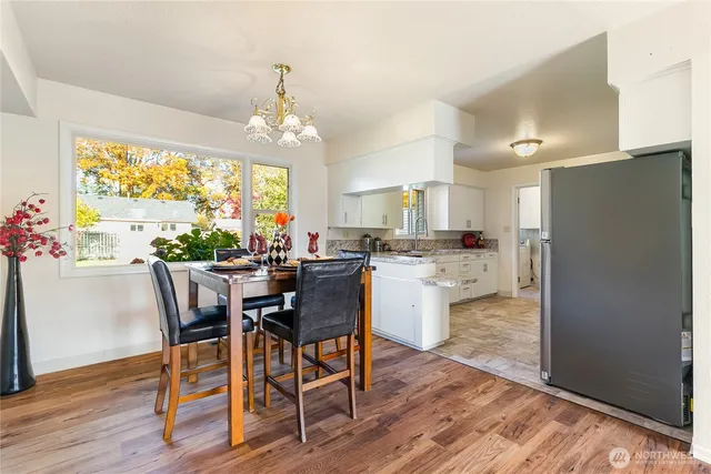 a view of a dining room with furniture window and wooden floor