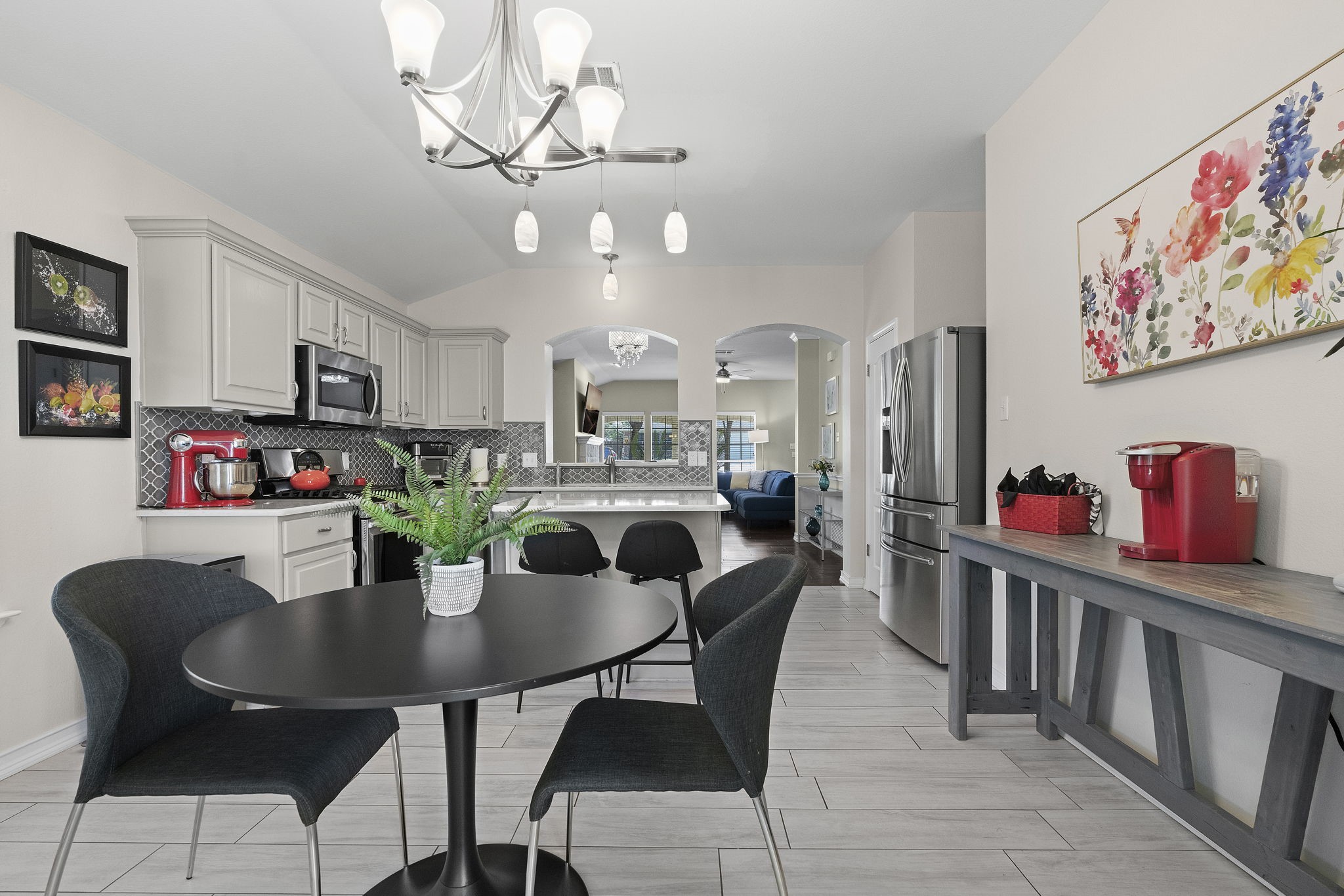 a view of a dining room with furniture and a chandelier