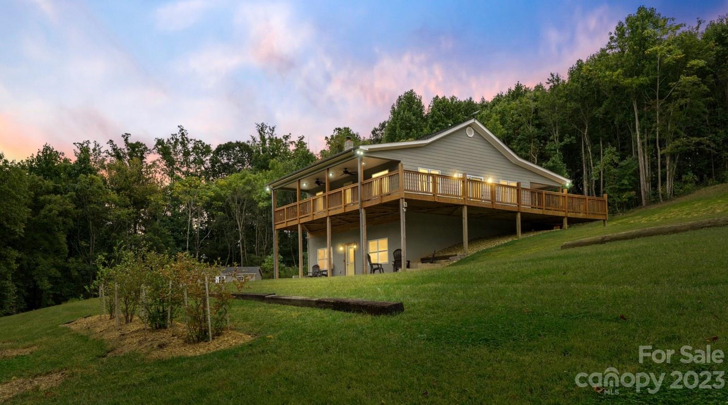 6363 Cheatham Ford Road Hiddenite, NC 28636 - Photo 1 of 32 a front view of a house with a garden