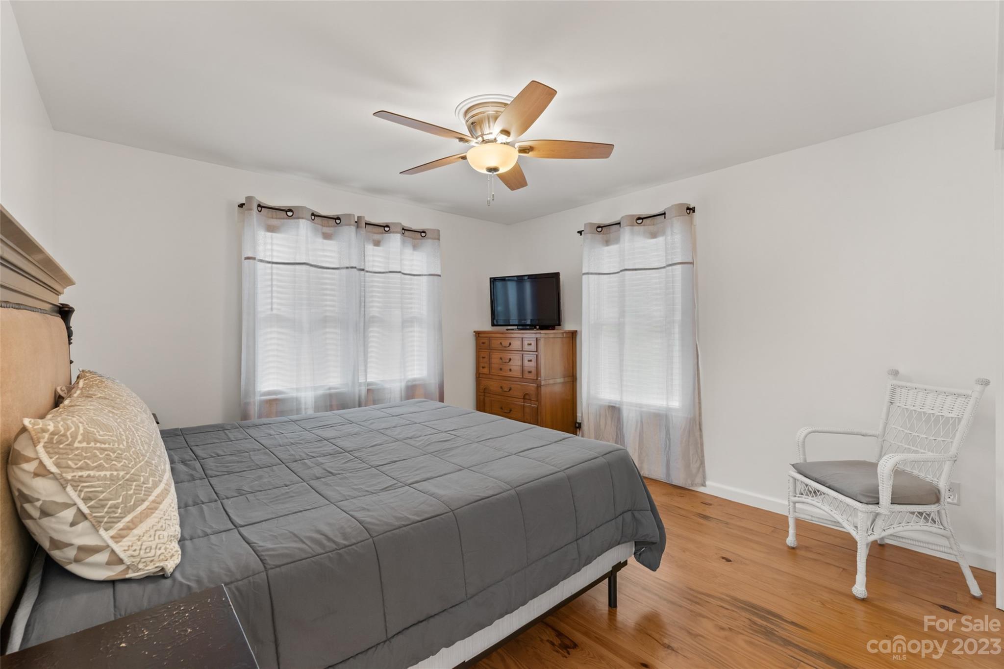 6363 Cheatham Ford Road Hiddenite, NC 28636 - Photo 17 of 32 a bedroom with a bed and a chandelier