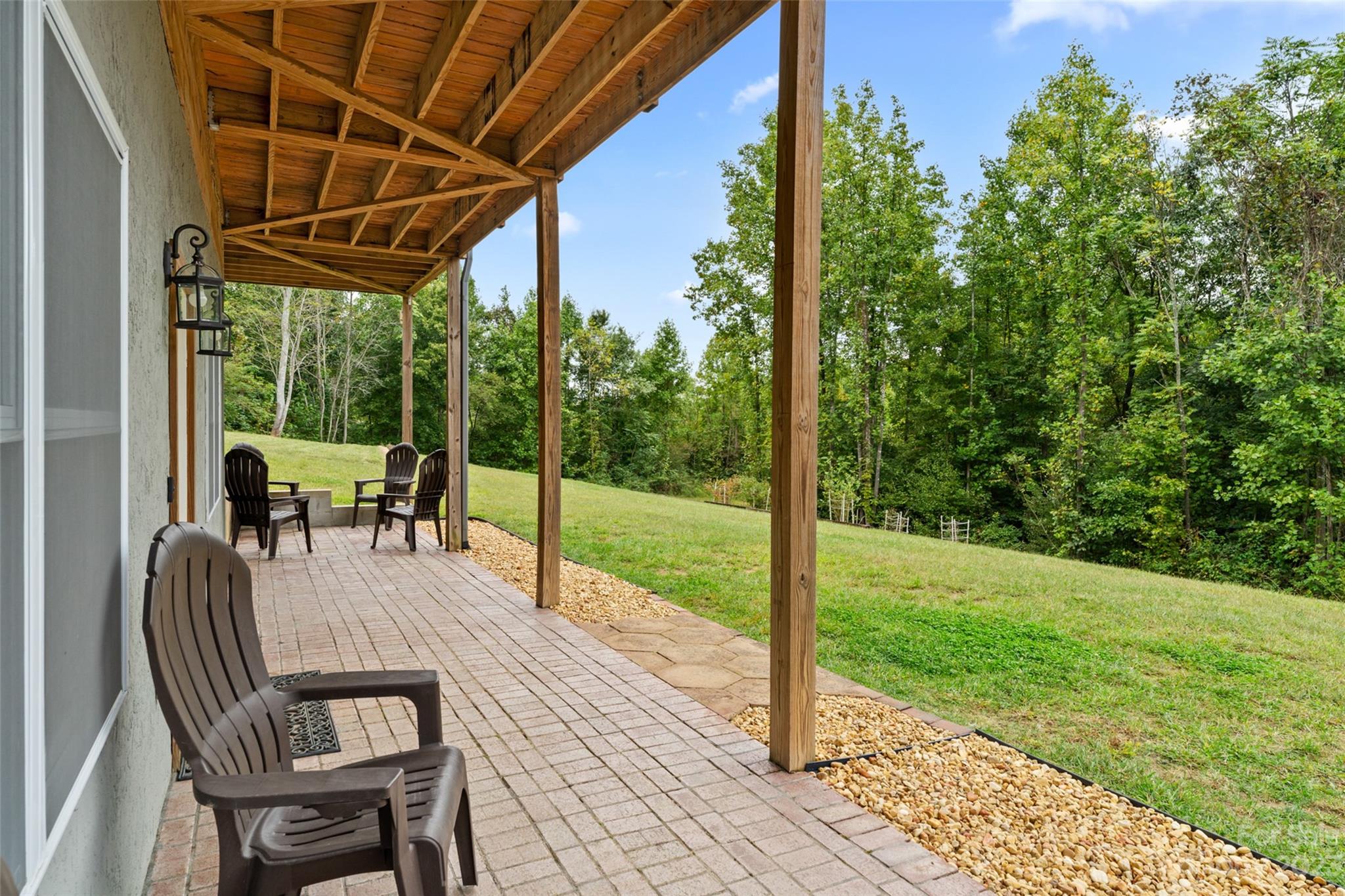 6363 Cheatham Ford Road Hiddenite, NC 28636 - Photo 25 of 32 a view of a patio with a table chairs and a backyard