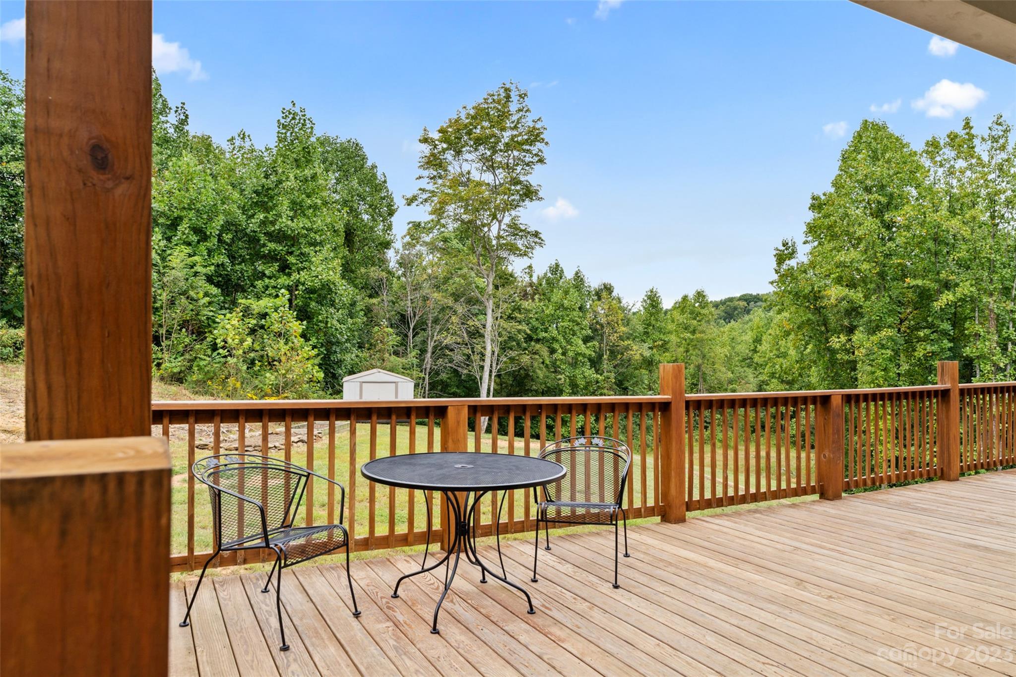 6363 Cheatham Ford Road Hiddenite, NC 28636 - Photo 26 of 32 a view of a balcony with wooden floor and outdoor seating