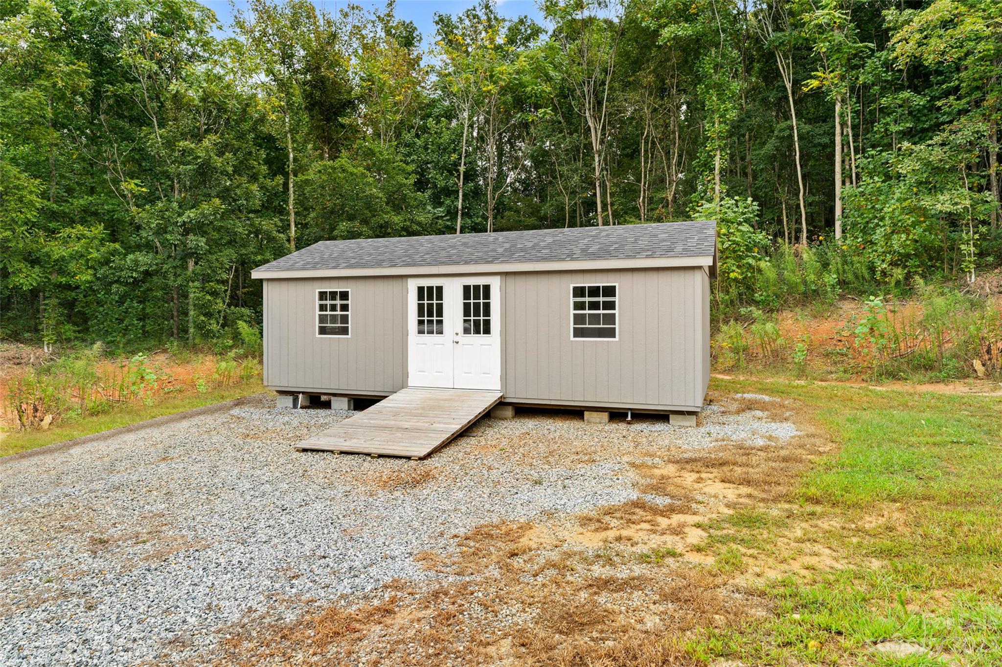 6363 Cheatham Ford Road Hiddenite, NC 28636 - Photo 27 of 32 a backyard of a house with large trees and wooden fence