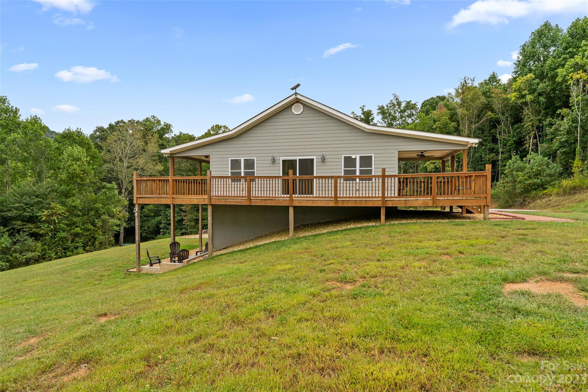 6363 Cheatham Ford Road Hiddenite, NC 28636 - Photo 32 of 32 a view of a house with a backyard and a garden