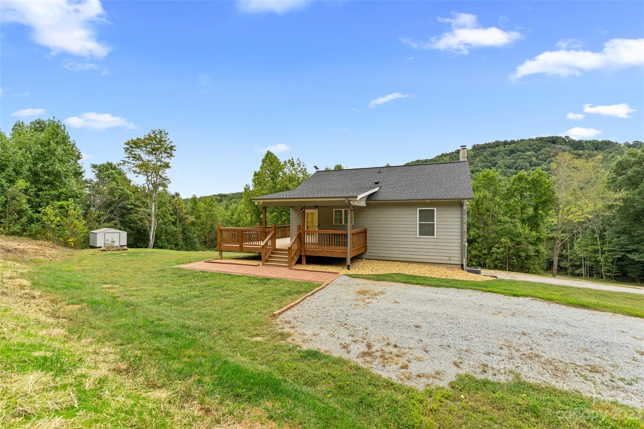 6363 Cheatham Ford Road Hiddenite, NC 28636 - Photo 9 of 32 a front view of a house with a garden and yard
