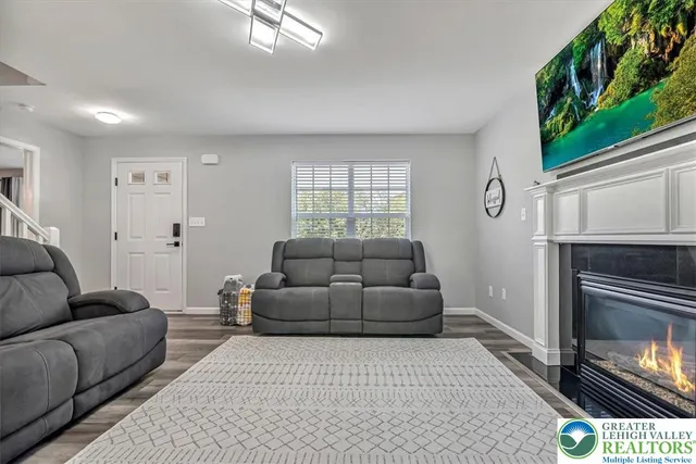 a kitchen with stainless steel appliances granite countertop a refrigerator a stove and a wooden floors