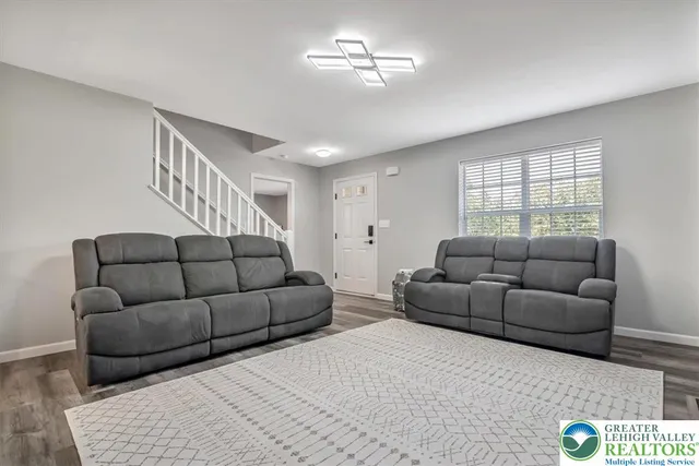 a kitchen with kitchen island granite countertop stainless steel appliances a stove a sink a refrigerator a center island and a window