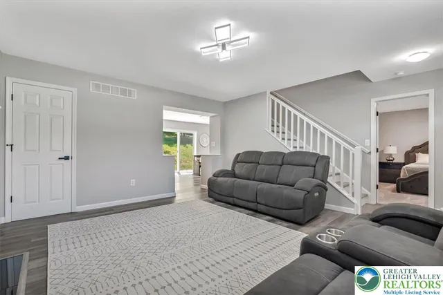 a kitchen with stainless steel appliances granite countertop a sink refrigerator and cabinets