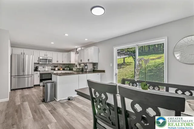 a kitchen with stainless steel appliances granite countertop a sink a stove top oven a counter space and cabinets