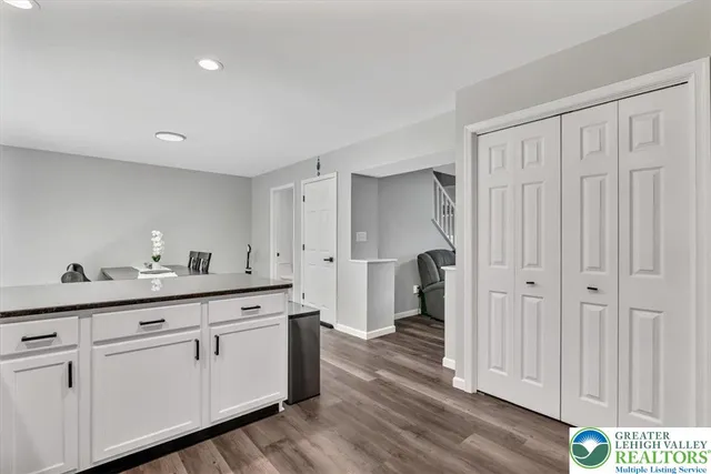 a spacious bedroom with a bed and wooden floor