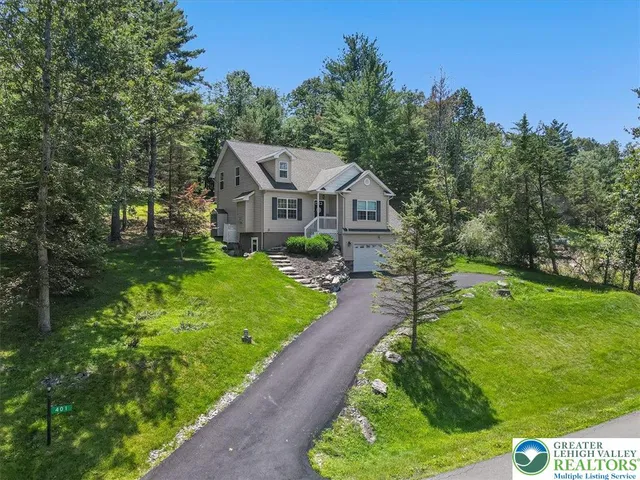 a front view of a house with a yard table and chairs