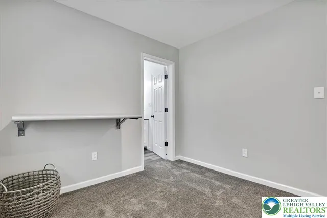 a view of a white house with a small yard and a large window