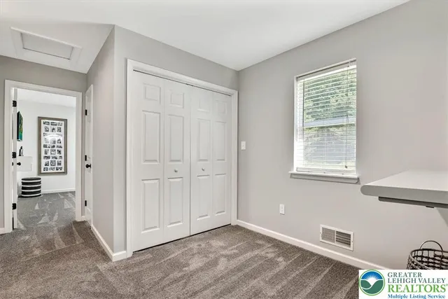 a view of backyard with table and chairs and potted plants