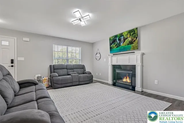 a living room with furniture ceiling fan and a window