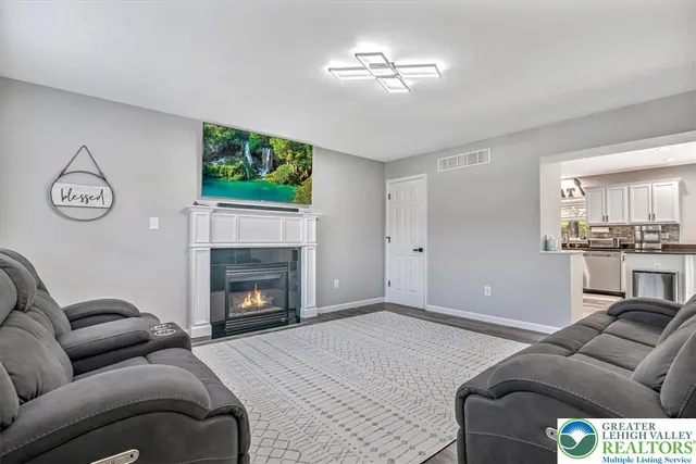 a living room with furniture and a ceiling fan