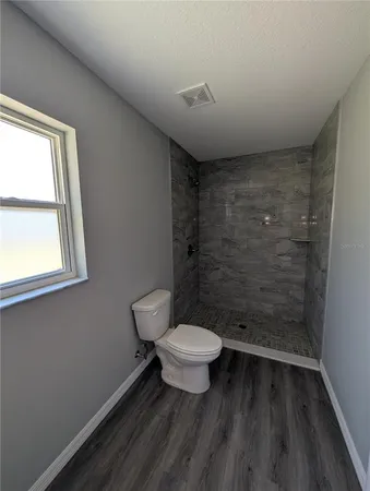 a bathroom with a toilet and a shower