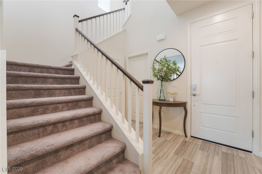 2556 Sable Ridge Street Henderson, NV 89044 - Photo 4 of 45 Foyer entrance with baseboards, stairs, and wood finished floors