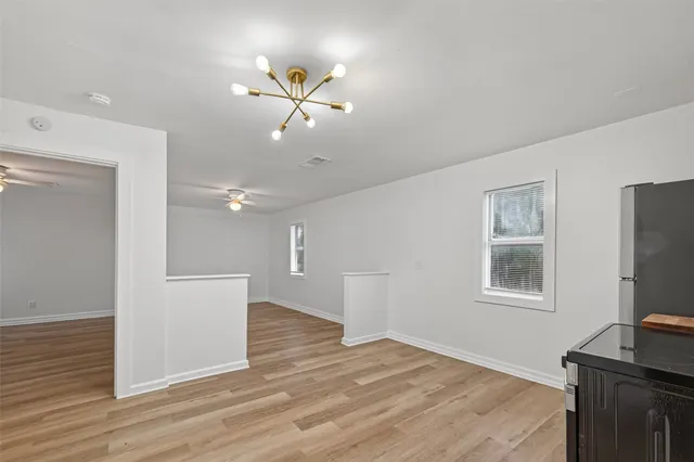a view of a livingroom with a flat screen tv and wooden floor