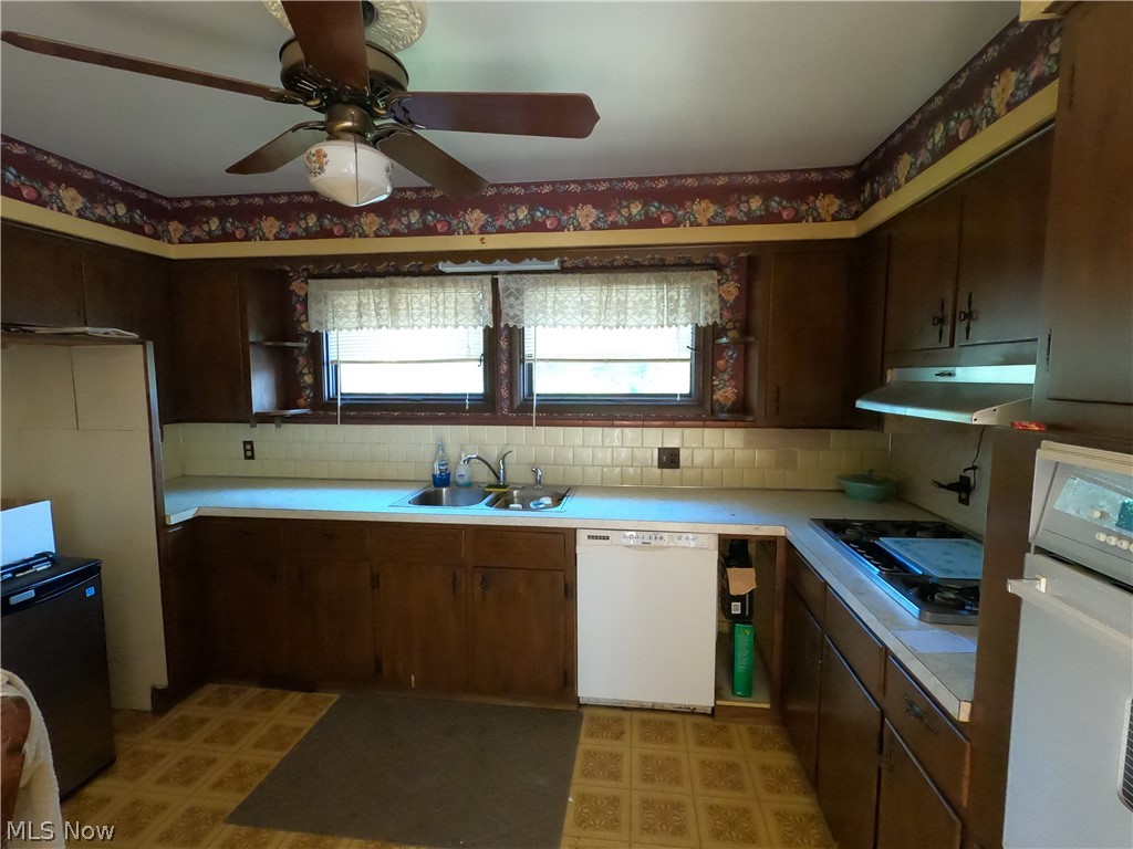 1425 Eastern Road Rittman, OH 44270 - Photo 13 of 28 Kitchen featuring wall oven, tasteful backsplash, dishwasher, black gas cooktop, and sink