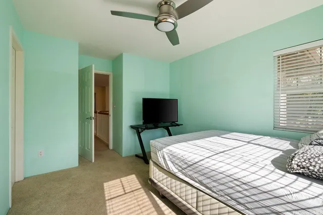 a bedroom with a large bed and a window