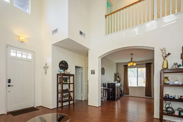 a view of a hallway with wooden floor and windows