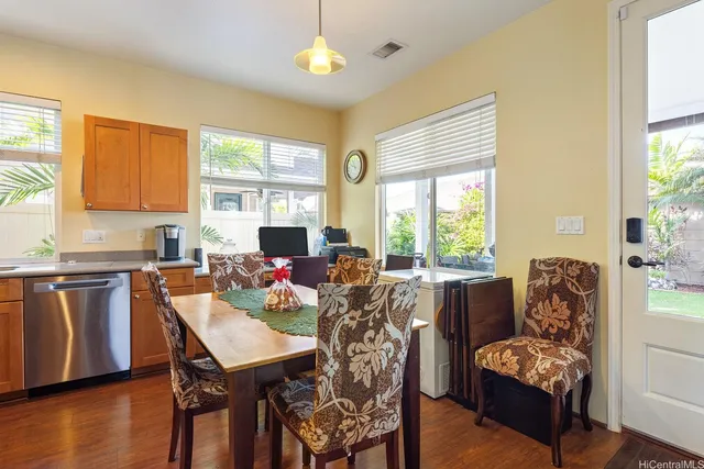 a dining room with furniture and wooden floor