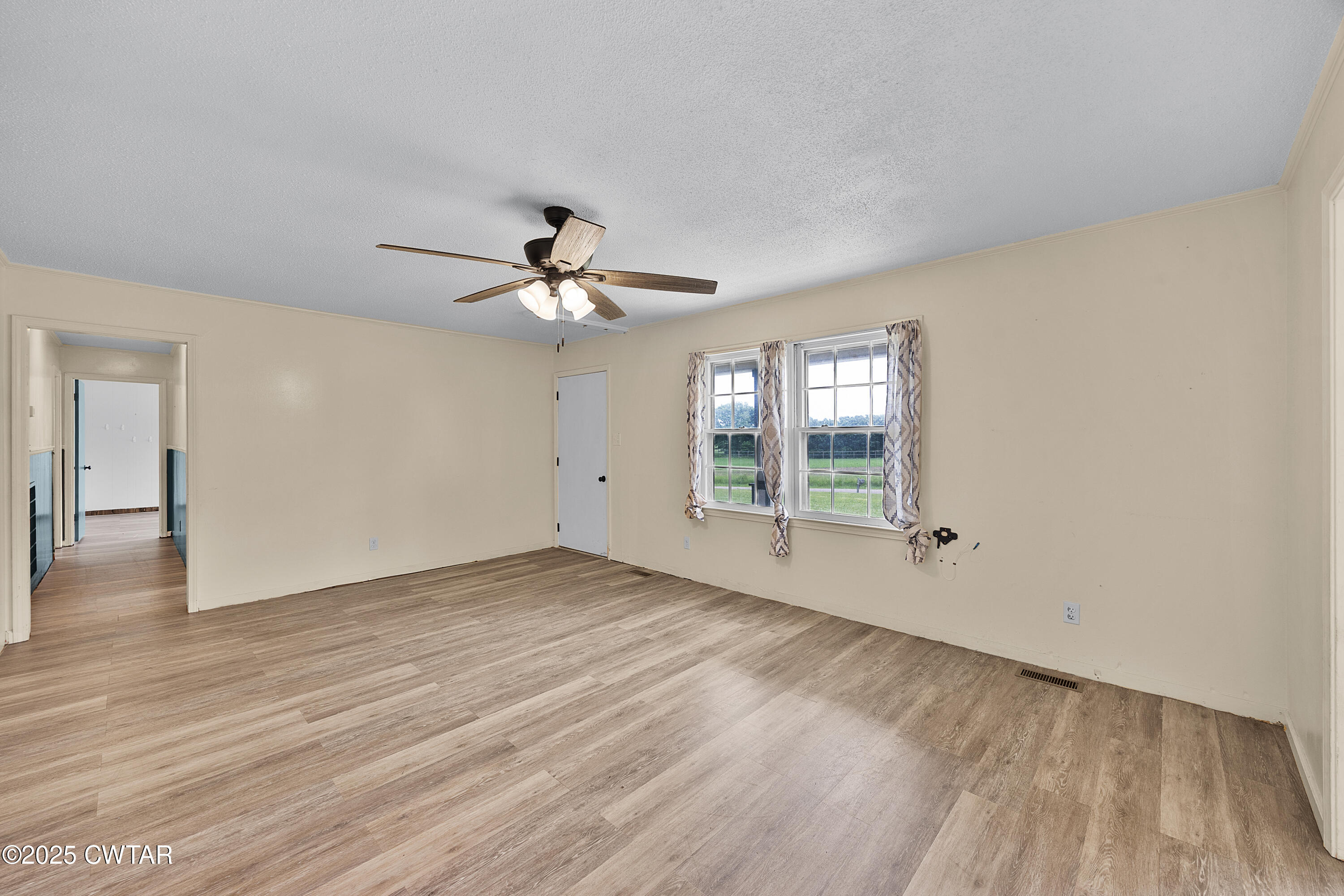 5790 Smyrna Road Westport, TN 38387 - Photo 14 of 26 a view of an empty room with window and wooden floor