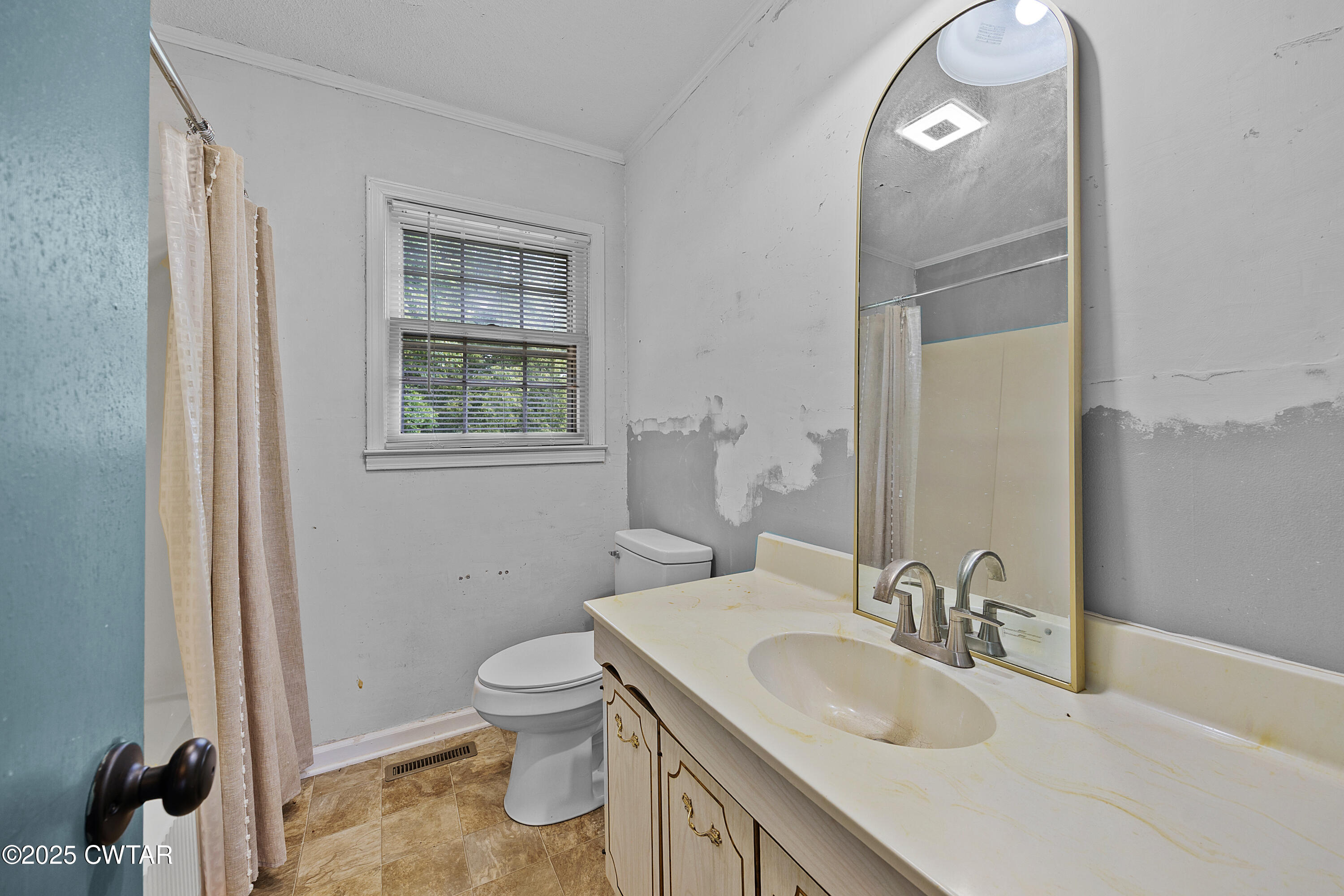 5790 Smyrna Road Westport, TN 38387 - Photo 18 of 26 a bathroom with a granite countertop toilet a sink and a mirror