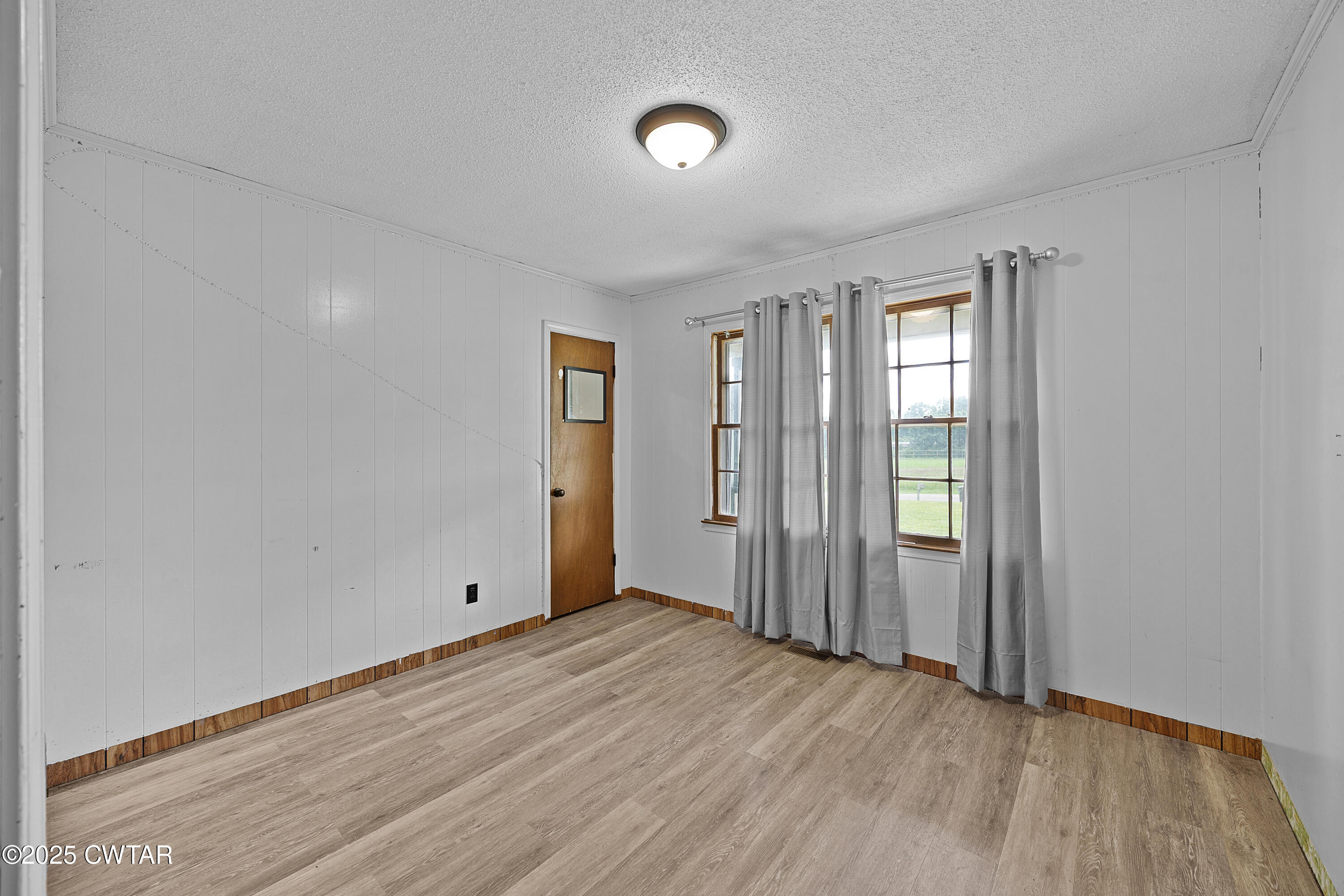 5790 Smyrna Road Westport, TN 38387 - Photo 19 of 26 an empty room with wooden floor and windows