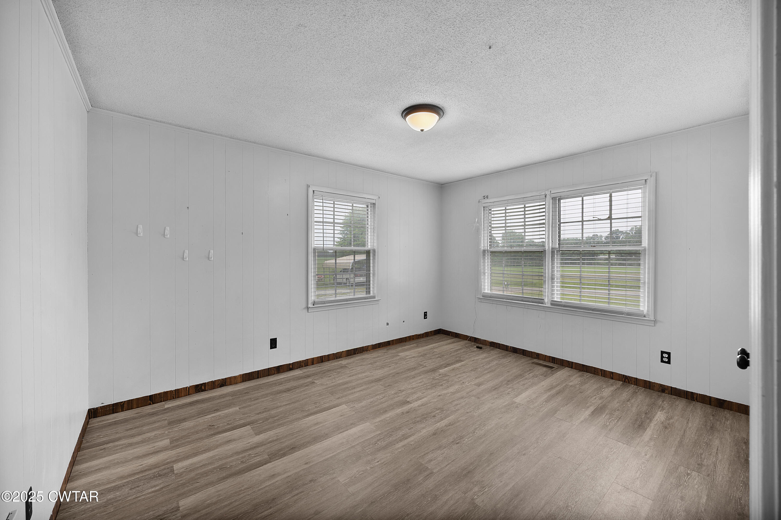 5790 Smyrna Road Westport, TN 38387 - Photo 23 of 26 an empty room with wooden floor and windows