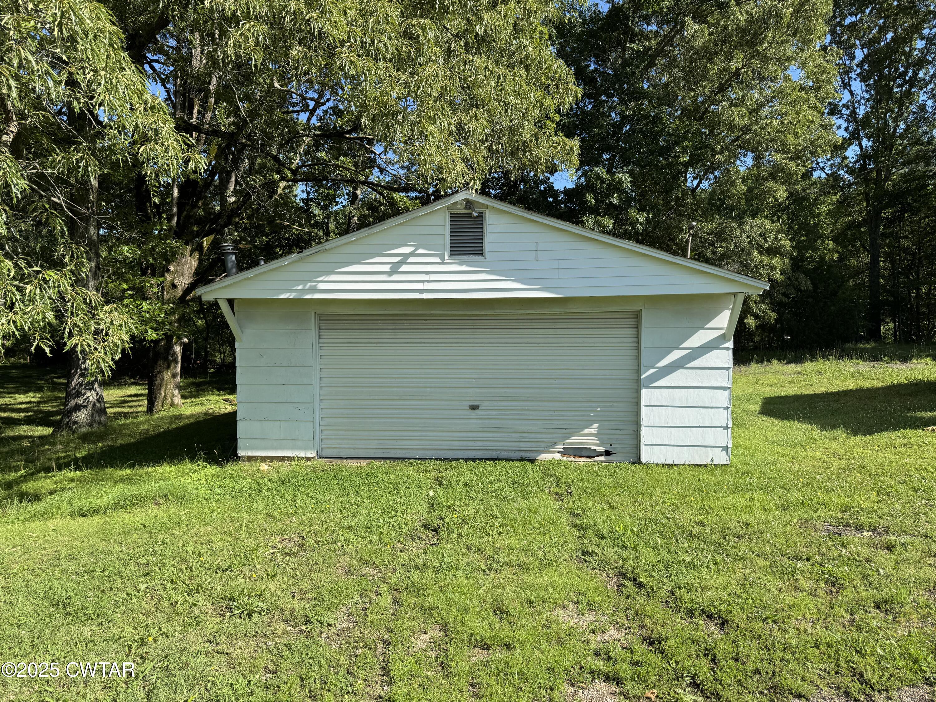 5790 Smyrna Road Westport, TN 38387 - Photo 25 of 26 a front view of house with yard and trees all around