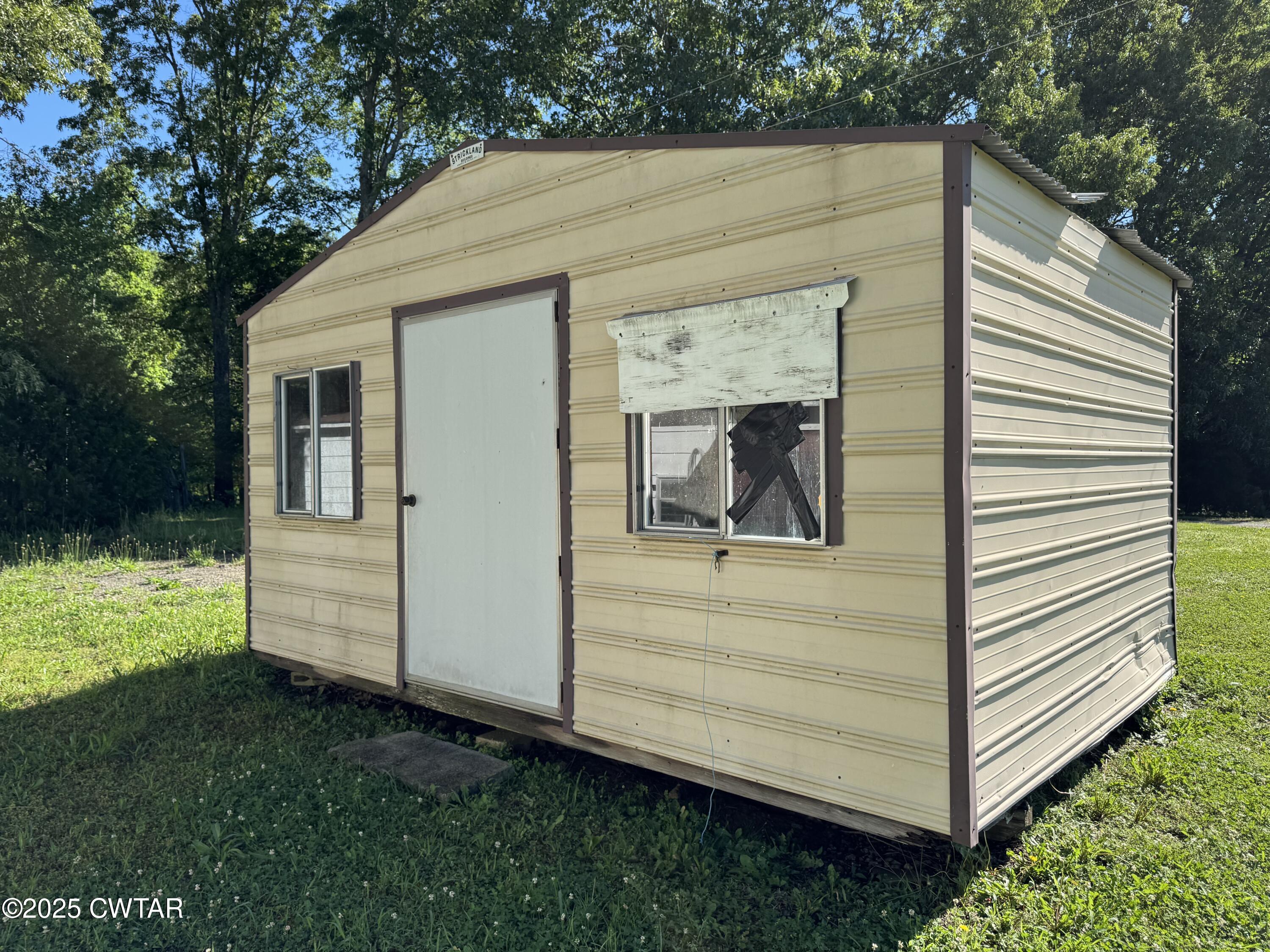 5790 Smyrna Road Westport, TN 38387 - Photo 26 of 26 a view of a small house with backyard