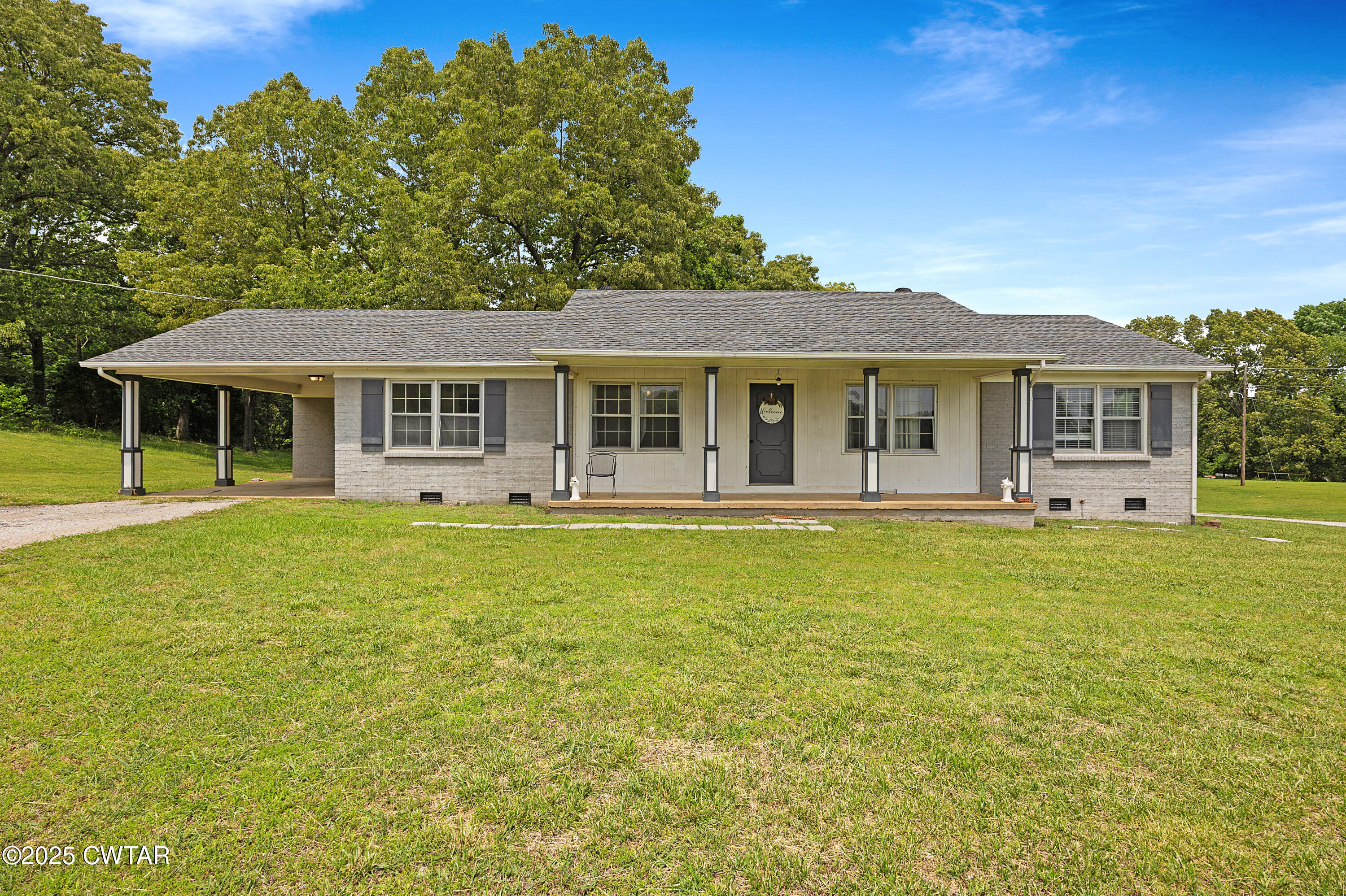 5790 Smyrna Road Westport, TN 38387 - Photo 4 of 26 a front view of a house with swimming pool having outdoor seating