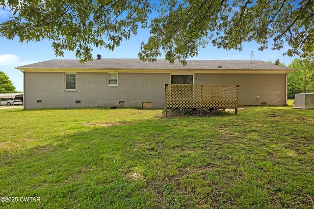 a view of a hallway with wooden floor and windows