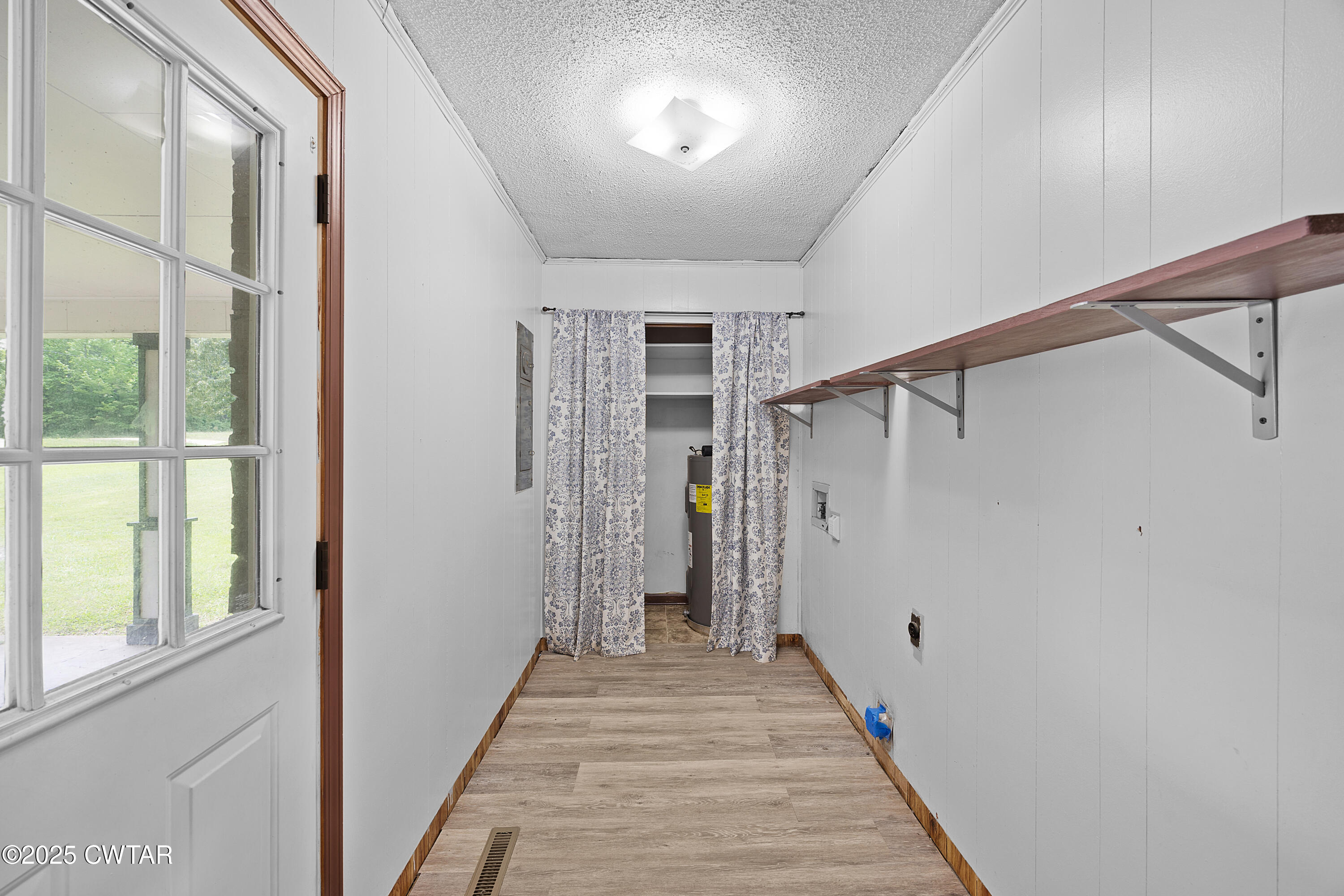 5790 Smyrna Road Westport, TN 38387 - Photo 7 of 26 a view of a hallway with wooden floor and windows