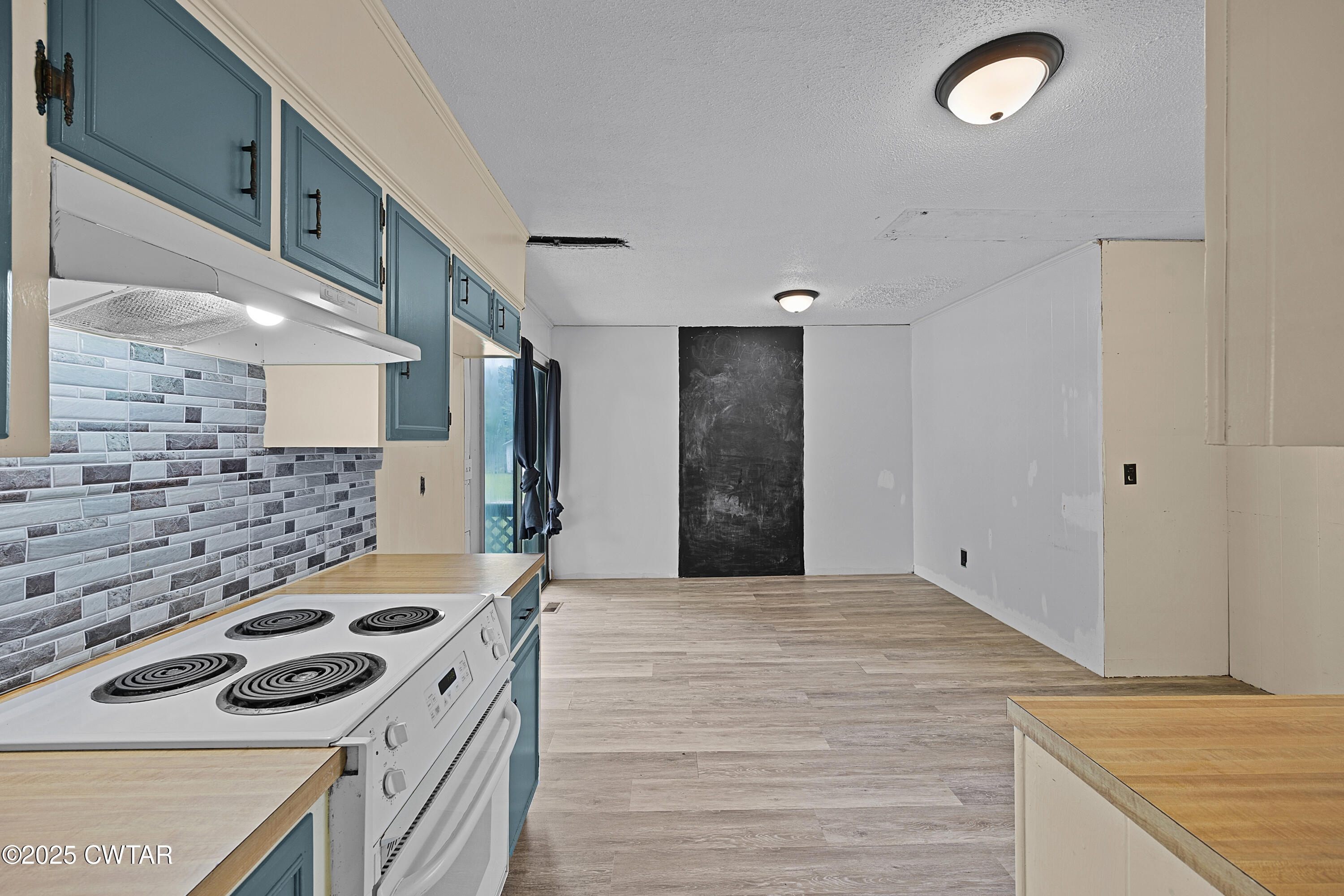 5790 Smyrna Road Westport, TN 38387 - Photo 8 of 26 a kitchen with a stove and a refrigerator