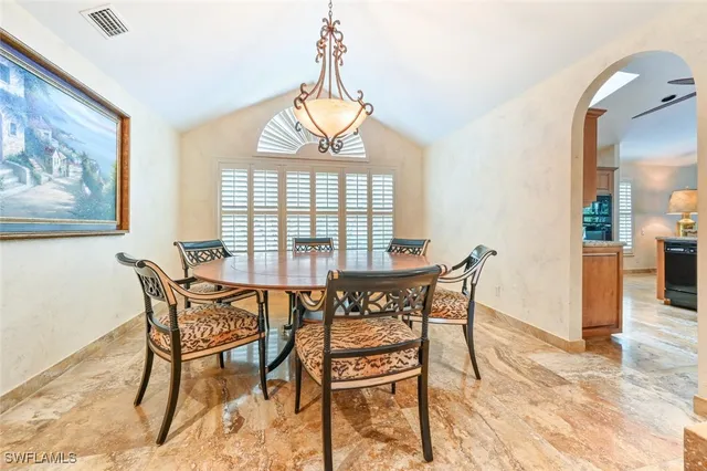 a living room with furniture a fireplace and a chandelier