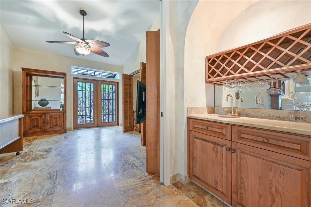 481 Crestwood Road Naples, FL 34113 - Photo 15 of 27 a spacious bathroom with a sink and a mirror