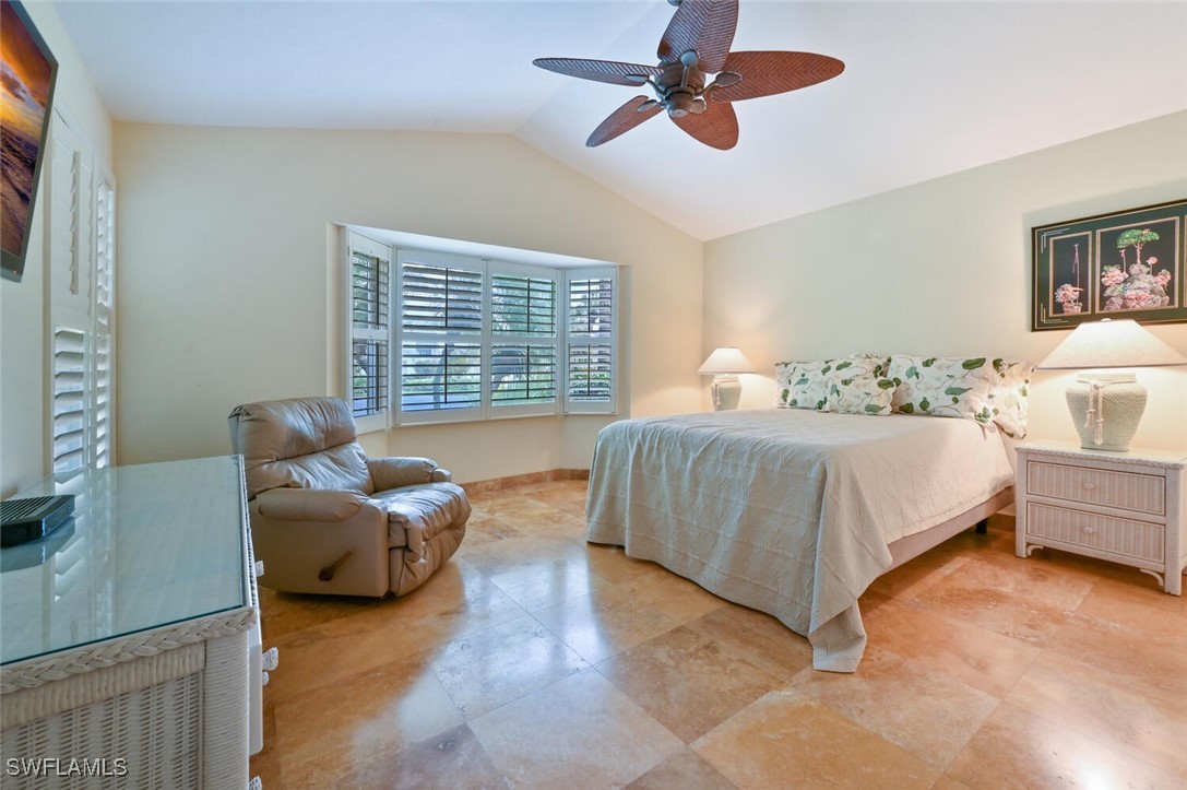 481 Crestwood Road Naples, FL 34113 - Photo 18 of 27 a bedroom with a bed and furniture