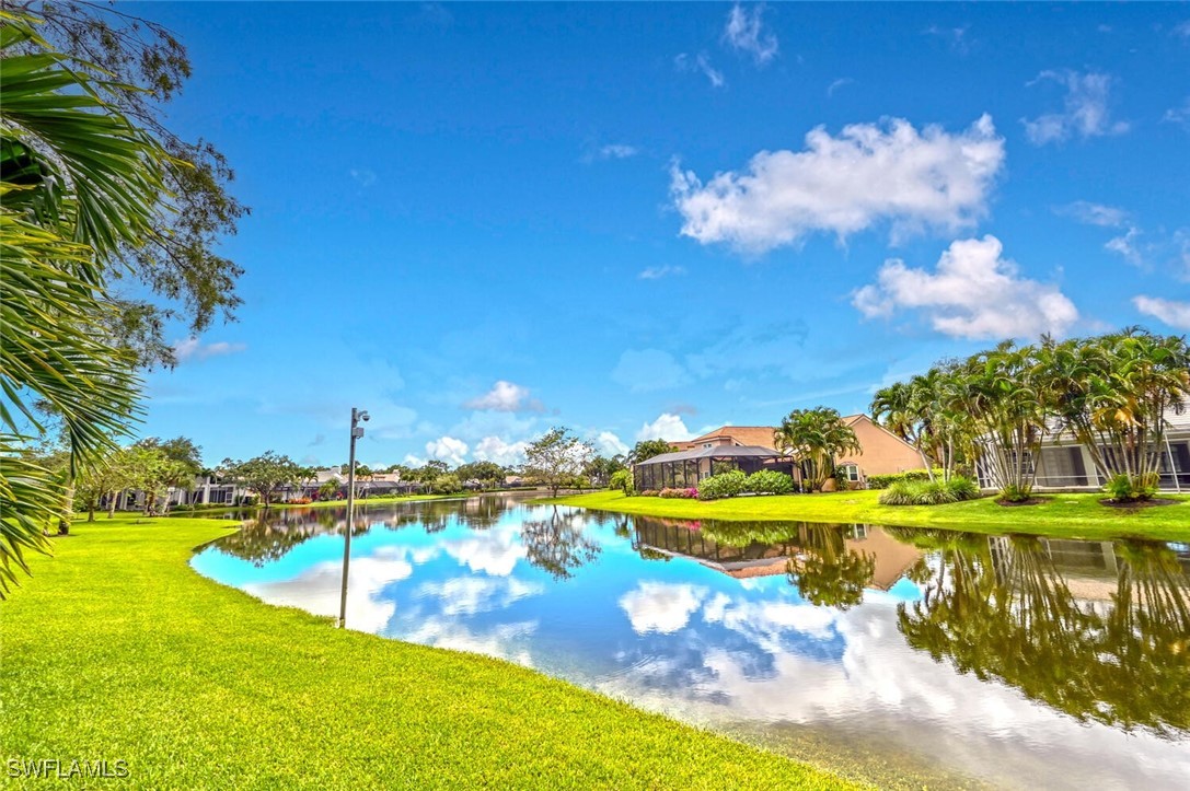 481 Crestwood Road Naples, FL 34113 - Photo 2 of 27 a view of a swimming pool with an outdoor space and seating area