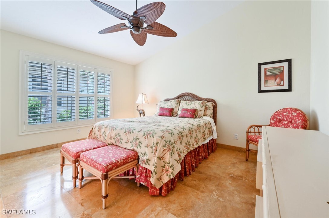 481 Crestwood Road Naples, FL 34113 - Photo 21 of 27 a bedroom with a bed and a chandelier