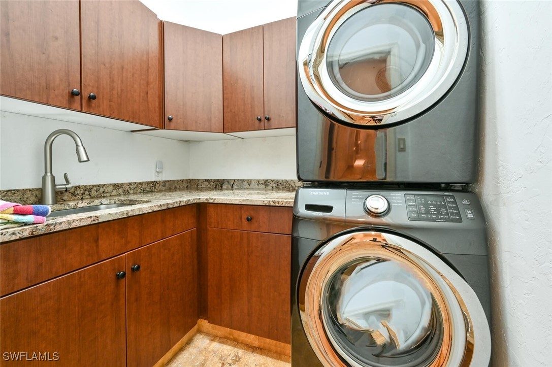 481 Crestwood Road Naples, FL 34113 - Photo 23 of 27 a close view of a utility room with dryer and washer