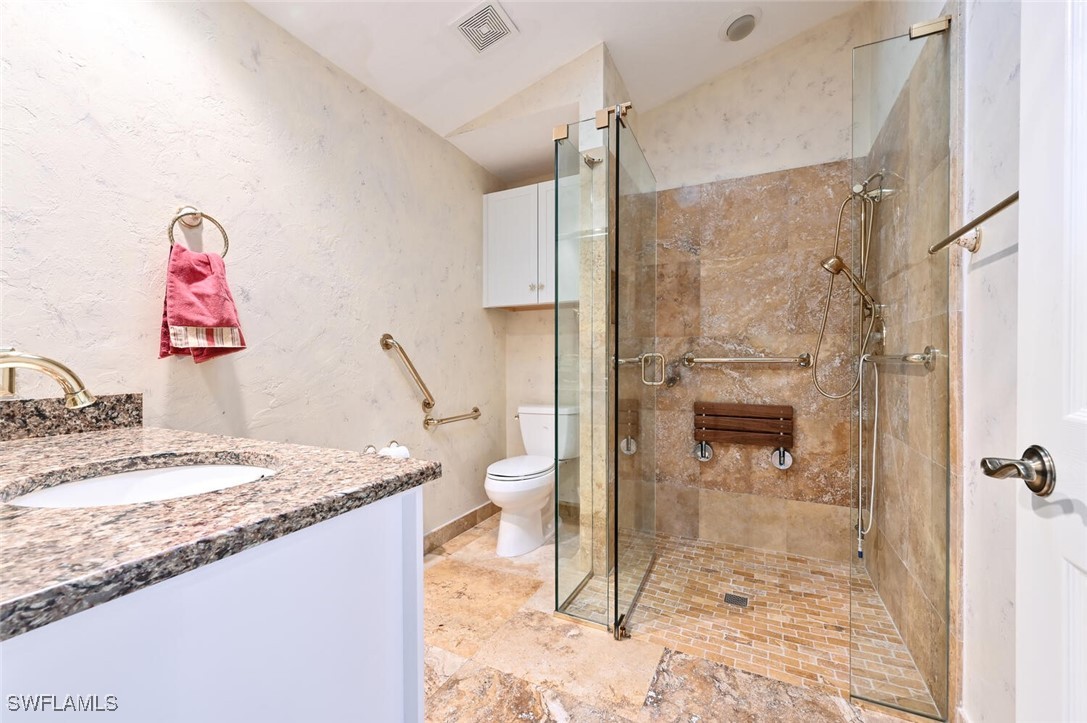 481 Crestwood Road Naples, FL 34113 - Photo 24 of 27 a bathroom with a granite countertop sink toilet and shower