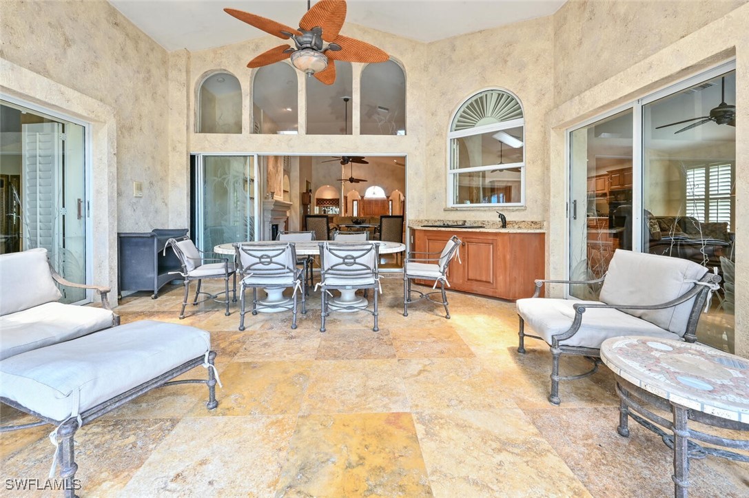 481 Crestwood Road Naples, FL 34113 - Photo 25 of 27 a living room with furniture chess table and a large window